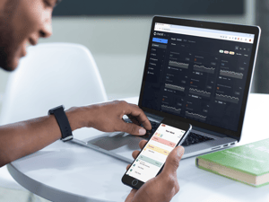 young-man-working-on-his-macbook-pro-laptop-and-iphone-6-mockup